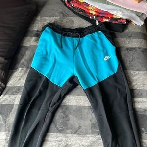 black and blue nike tech pants